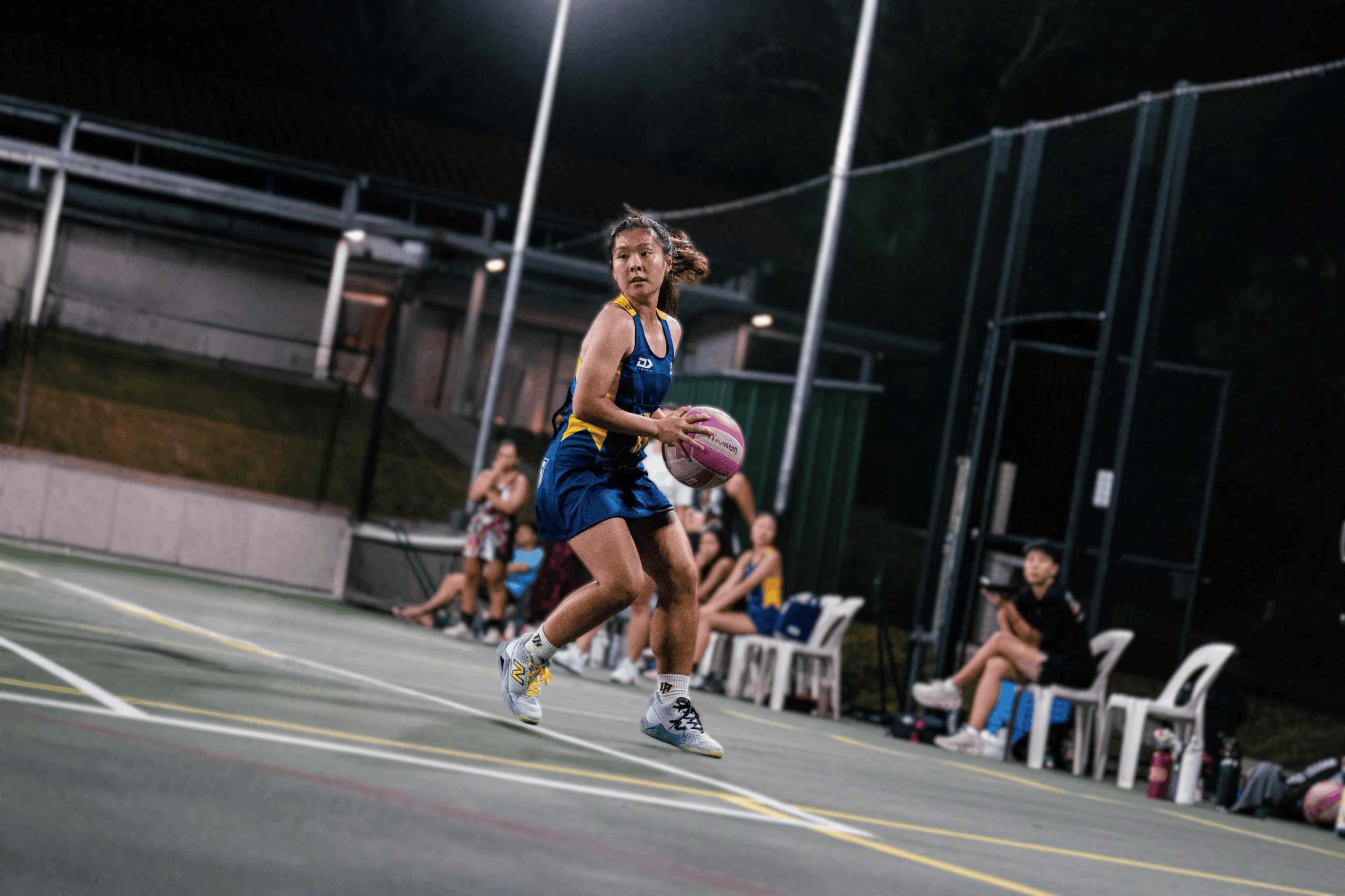 Dauntelica Rhinos netball athlete poised to pass under floodlights