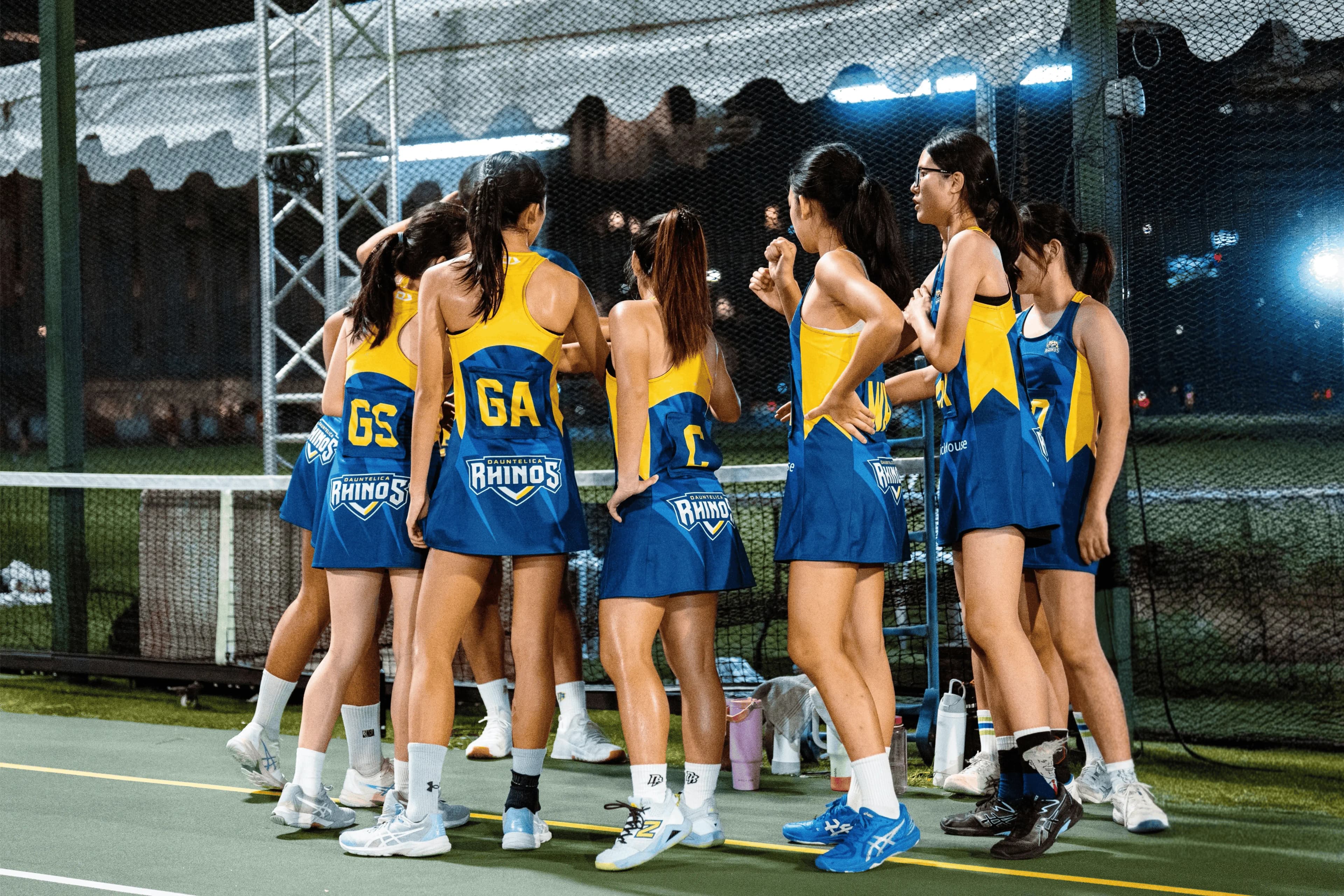 Dauntelica Rhinos players in official competition uniform team huddle